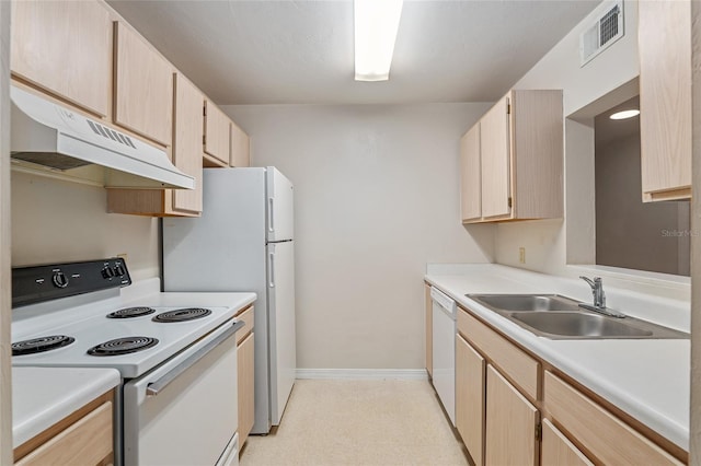 kitchen with white appliances, sink, and light brown cabinets