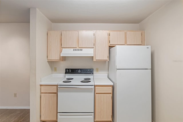 kitchen with light brown cabinetry, white appliances, and carpet