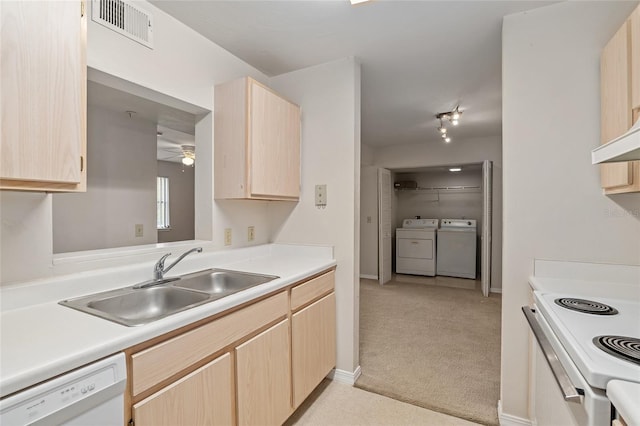 kitchen with light brown cabinetry, sink, light colored carpet, ceiling fan, and white appliances