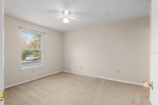 unfurnished room featuring light colored carpet and ceiling fan