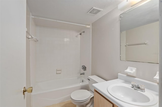 full bathroom with vanity, tiled shower / bath combo, and toilet