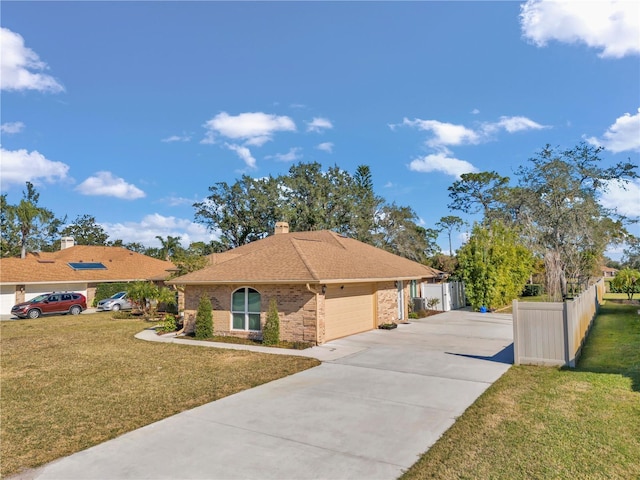 view of front of home featuring brick siding, a chimney, fence, a garage, and a front lawn