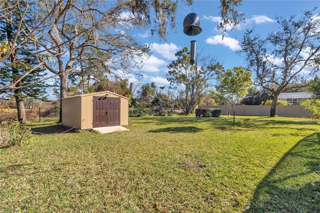 view of yard with a fenced backyard, an outdoor structure, and a shed