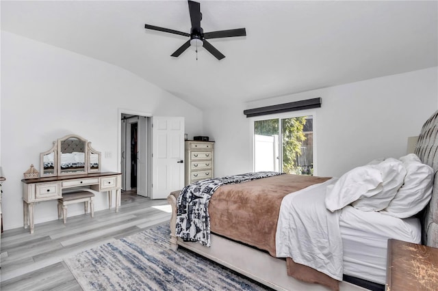 bedroom with light wood-type flooring, a ceiling fan, and lofted ceiling