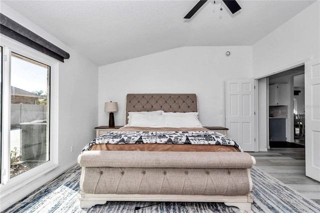 bedroom featuring ceiling fan, vaulted ceiling, and wood finished floors