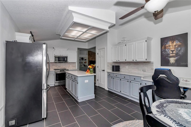 kitchen featuring white cabinetry, stainless steel appliances, light countertops, and a center island