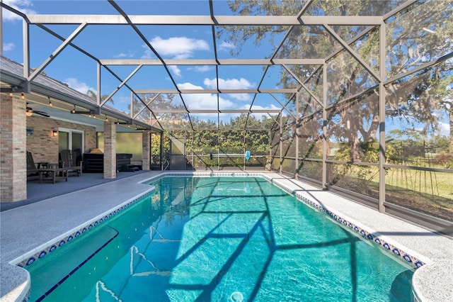 pool with a lanai and a patio area