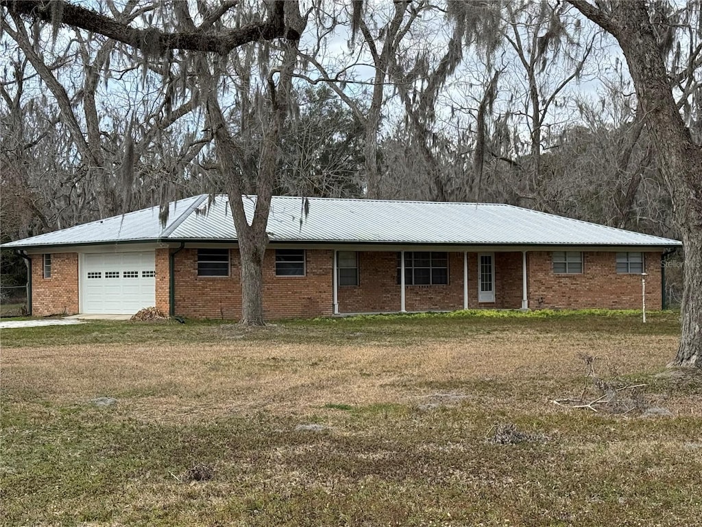 ranch-style house with a garage and a front yard