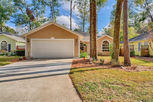 ranch-style home featuring a garage and a front yard