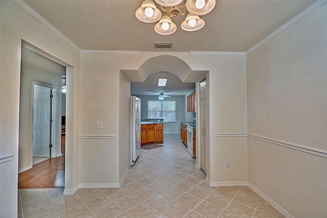 kitchen featuring light tile patterned floors, white appliances, ceiling fan with notable chandelier, and ornamental molding