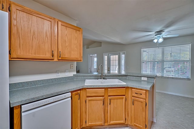 kitchen featuring sink, light tile patterned floors, dishwasher, kitchen peninsula, and ceiling fan