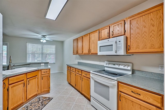 kitchen featuring light tile patterned flooring, sink, ceiling fan, and white appliances