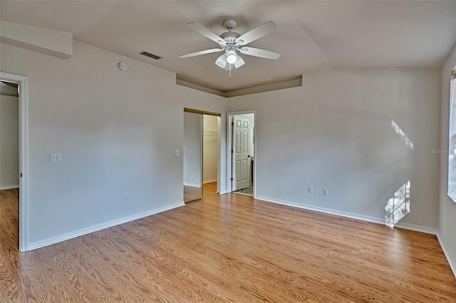 spare room featuring ceiling fan, vaulted ceiling, and light hardwood / wood-style floors