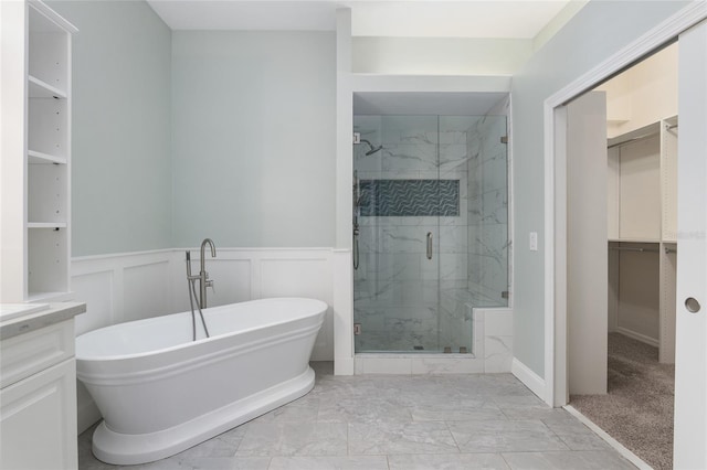 bathroom featuring shower with separate bathtub and vanity