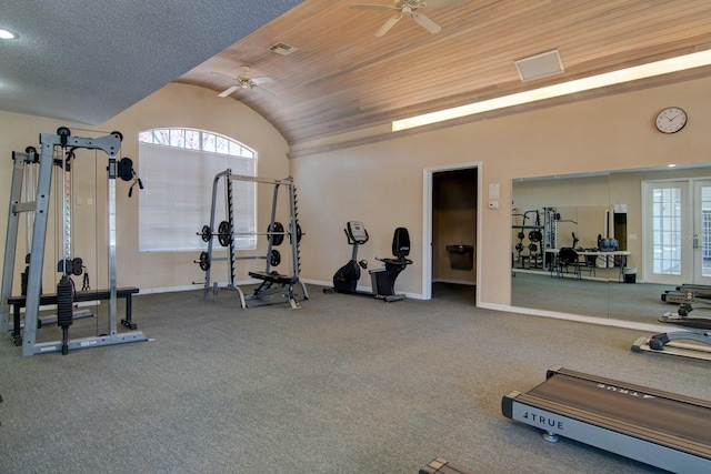 gym with ceiling fan, vaulted ceiling, wooden ceiling, and a healthy amount of sunlight