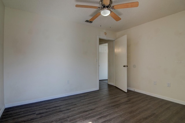 spare room with dark hardwood / wood-style floors and ceiling fan