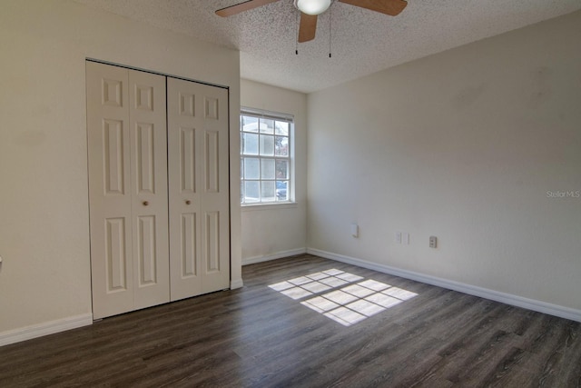 unfurnished bedroom featuring ceiling fan, dark hardwood / wood-style floors, a textured ceiling, and a closet