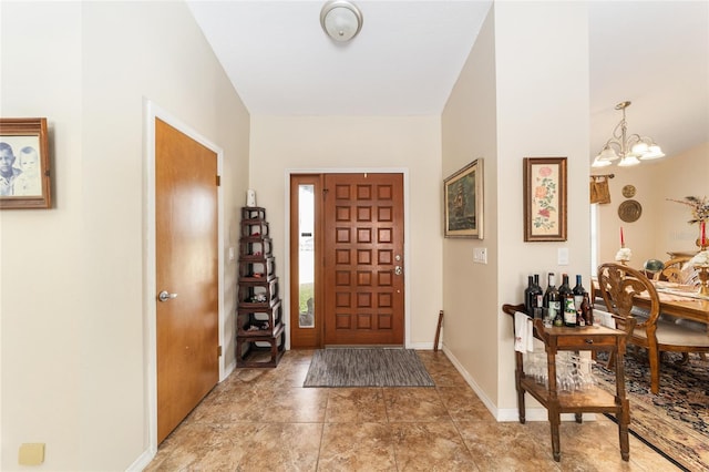 foyer entrance with a notable chandelier