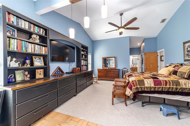 bedroom with vaulted ceiling, light colored carpet, and ensuite bath