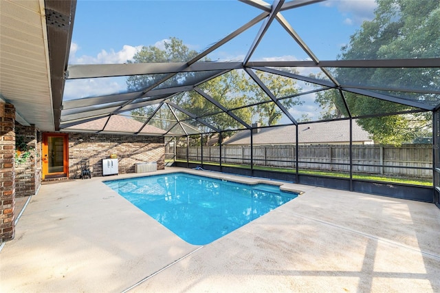 view of swimming pool with a lanai and a patio area