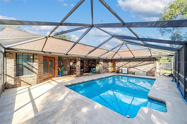 view of pool with a lanai and a patio area