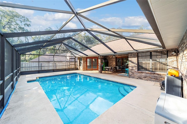 view of swimming pool with a lanai and a patio