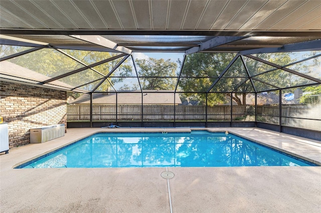 view of pool featuring a patio area and glass enclosure