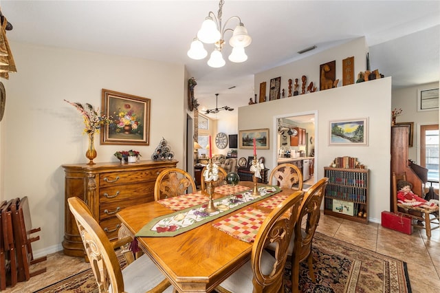 tiled dining room with a notable chandelier