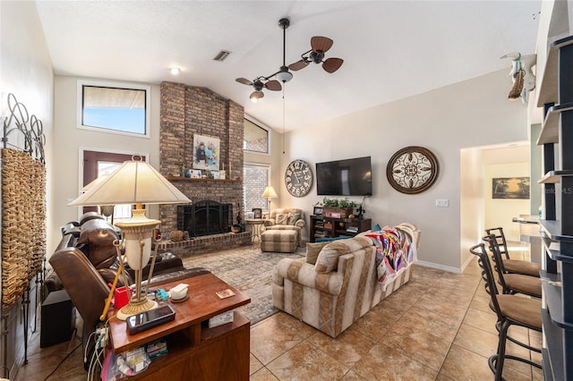 living room featuring light tile patterned floors, a fireplace, high vaulted ceiling, and ceiling fan