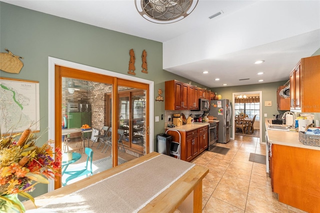 kitchen with sink, stainless steel appliances, and light tile patterned flooring