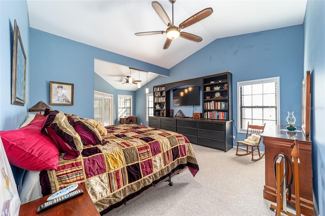 carpeted bedroom featuring multiple windows, vaulted ceiling, and ceiling fan