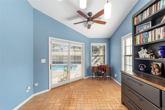 office space featuring vaulted ceiling and ceiling fan