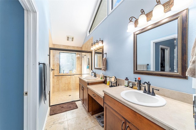 bathroom with tile patterned floors, a shower with shower door, and vanity