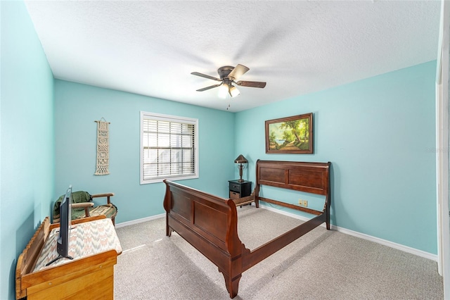 carpeted bedroom with ceiling fan and a textured ceiling