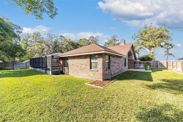 view of side of home featuring a yard and a lanai