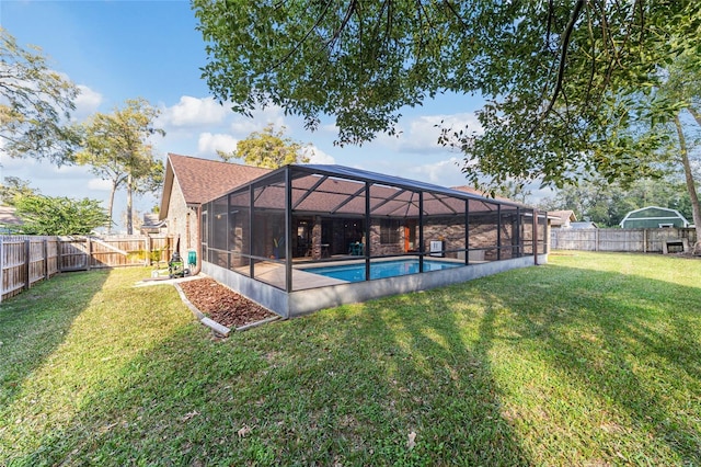 view of pool featuring glass enclosure and a lawn