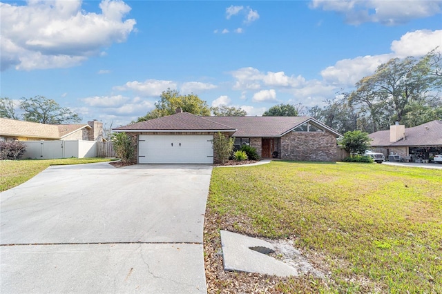 single story home featuring a garage and a front lawn