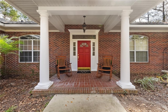 view of exterior entry featuring a porch