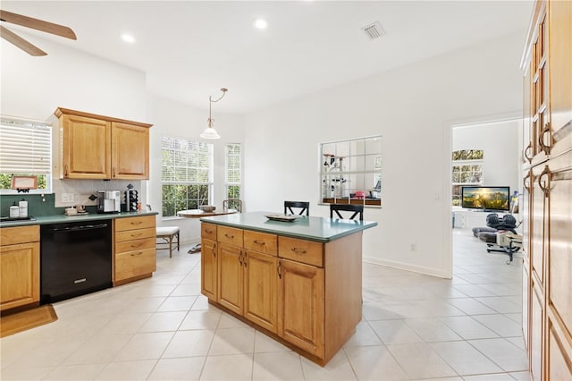 kitchen featuring pendant lighting, backsplash, black dishwasher, and light tile patterned floors