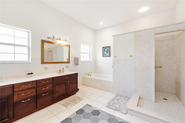 bathroom with vanity, tile patterned floors, and plus walk in shower