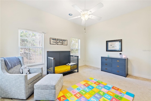 bedroom with a nursery area and light colored carpet