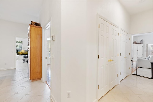 corridor with light tile patterned flooring