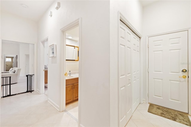 hallway with sink and light tile patterned floors