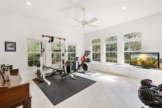 workout area featuring light tile patterned flooring and ceiling fan