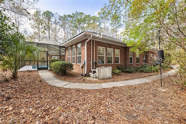 view of property exterior with glass enclosure