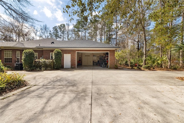 view of home's exterior with cooling unit and a garage