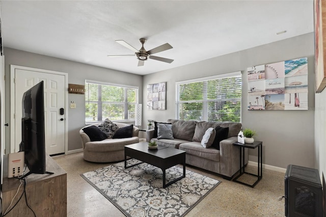 living room featuring heating unit and ceiling fan