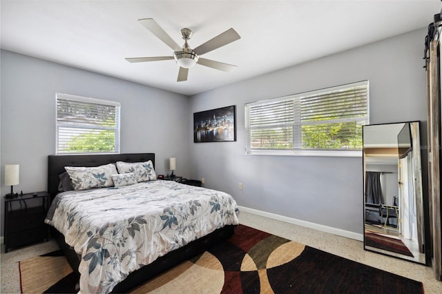 bedroom featuring ceiling fan and multiple windows