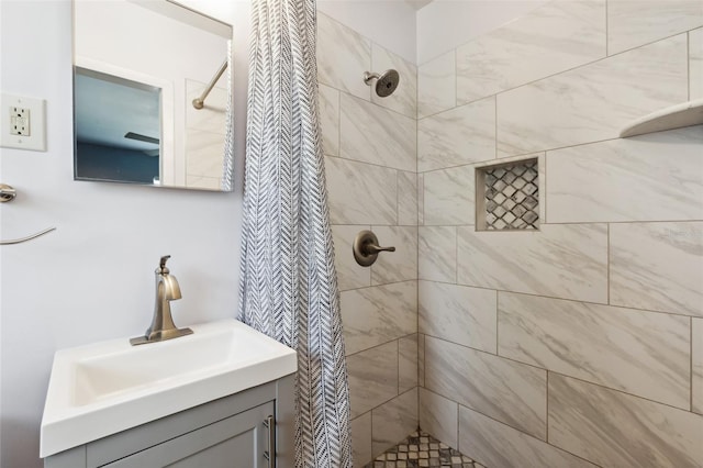 bathroom featuring vanity and a tile shower