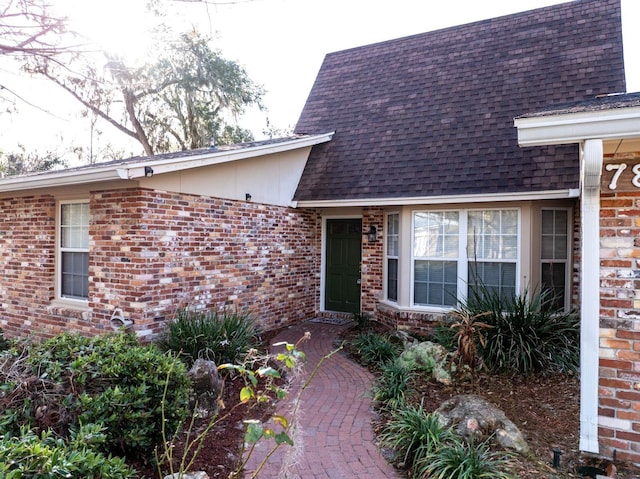 view of exterior entry featuring a patio area